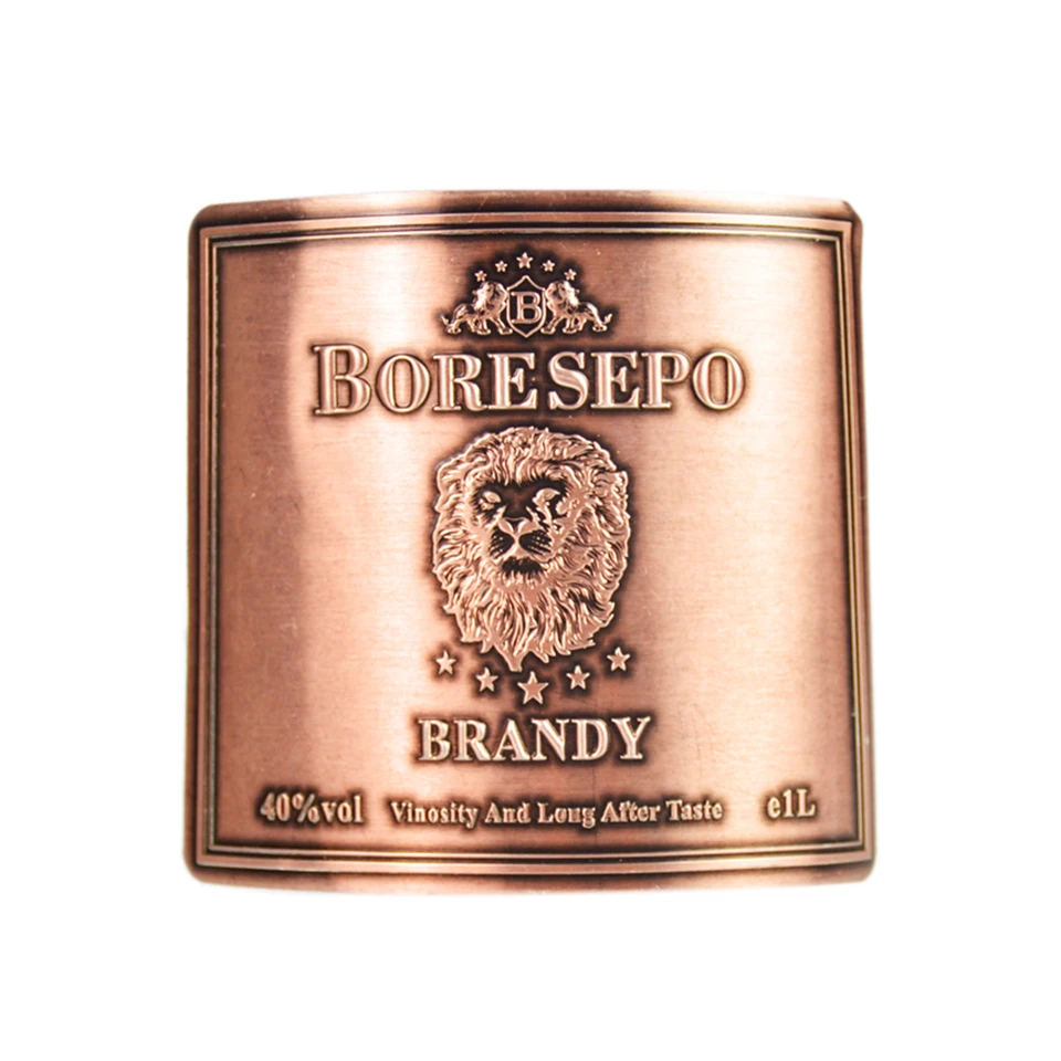 lion embossed antique copper brandy bottle tag front view
