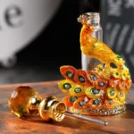 ornate peacock perfume bottle accessory gem stopper closeup