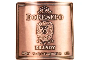 lion embossed antique copper brandy bottle tag front view